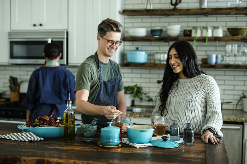 Man and woman in a commercial kitchen examine types of edibles. People enjoy creating creative and delicious cannabis treats - Earthy Select