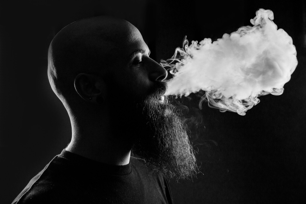 Bearded bald man exhales smoke. Modern cannabis can have high THC levels. High Times Indeed: Tracing the Potent Evolution of THC in Cannabis. Earthy Select. 